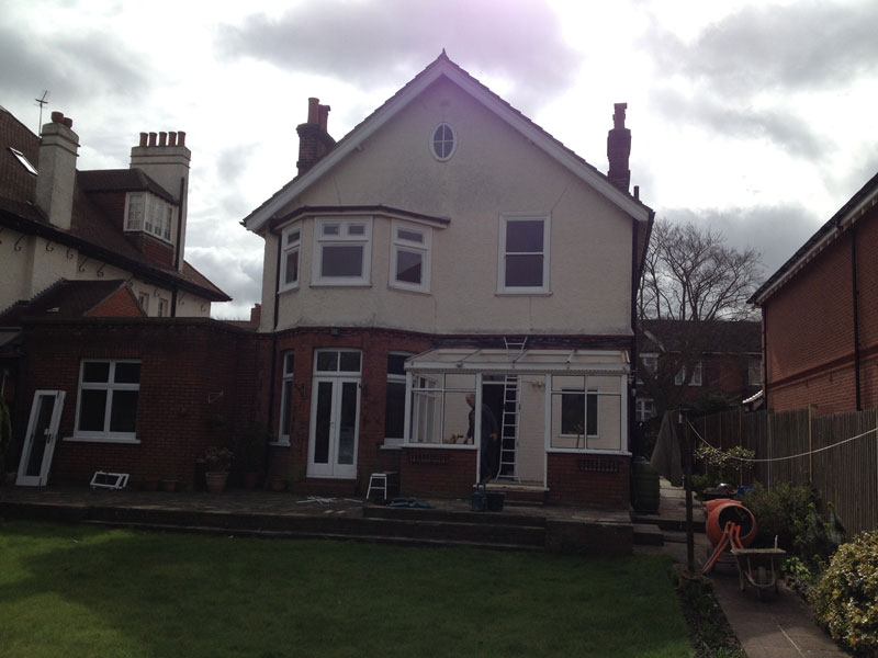 Wide garden view of a house and rear extension during work