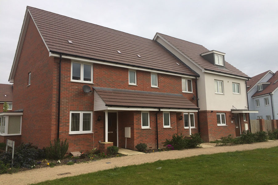 Newly built brick homes on a modern street with tiled roofs