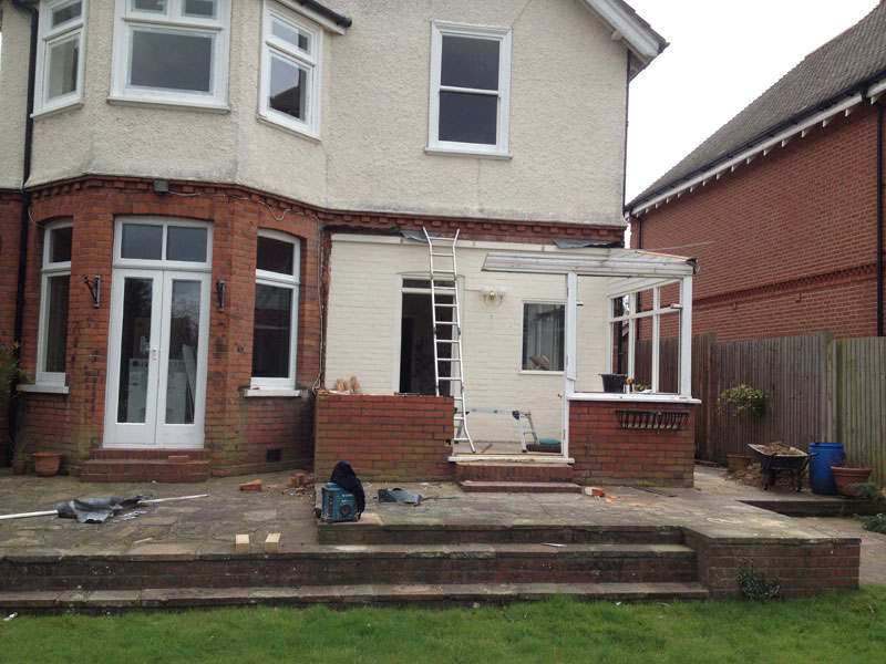 Rear view of an extension during building work, with partial brick walls