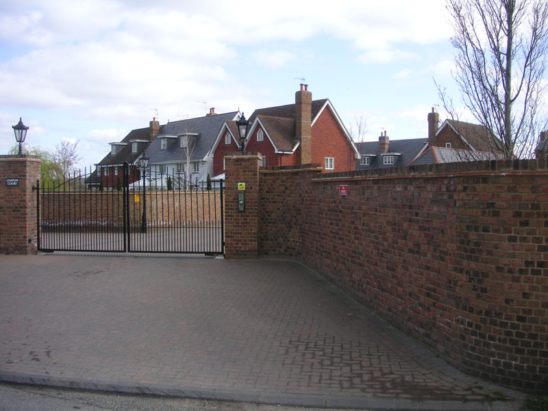 Brick perimeter wall and gated entrance to a new development